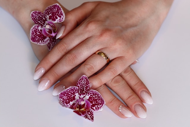 3D acrylic Queen of Hearts nails with sculpted heart embellishments
