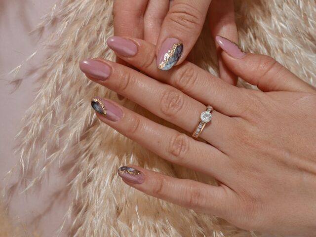 Queen of Hearts nails design with rhinestones and glitter accents
