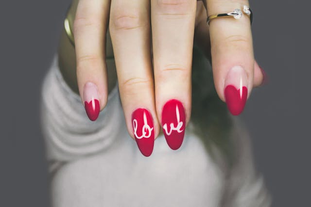 Classic Queen of Hearts nails design in red and white polish with heart