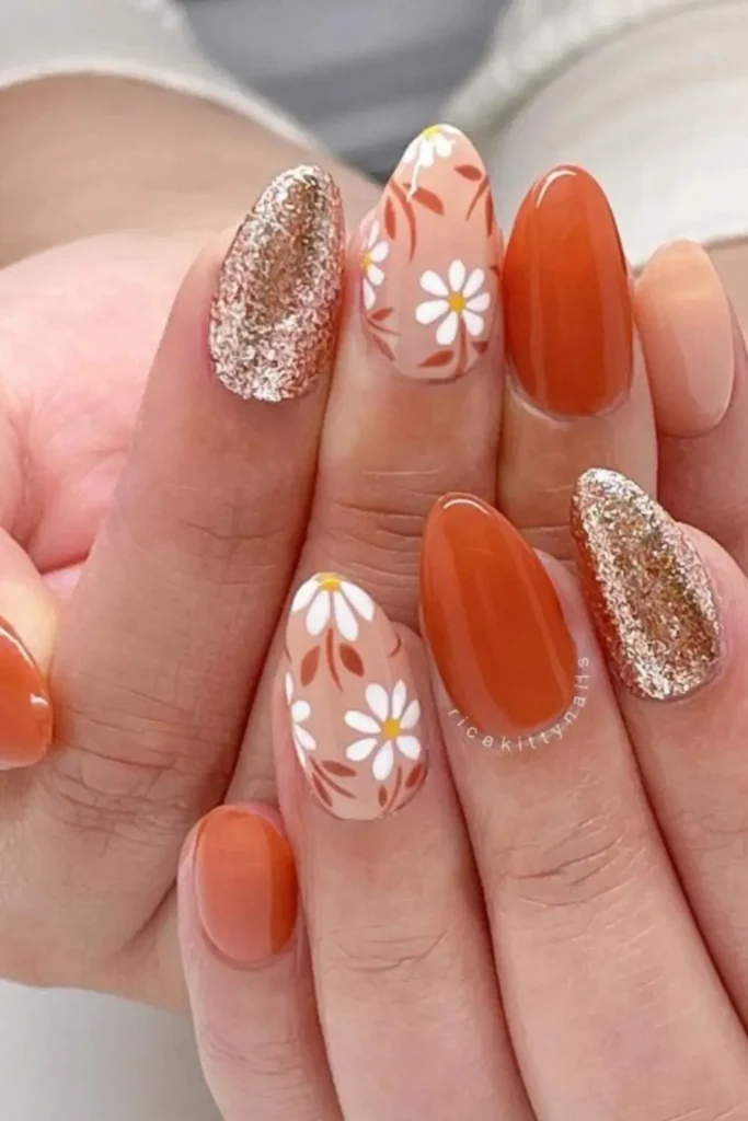 Long coffin nails with deep green and black ombre and gold foil details.