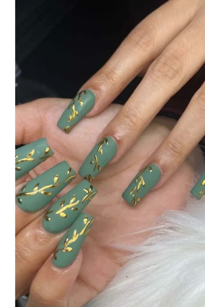 Matte olive green long nails with gold leaf accents.