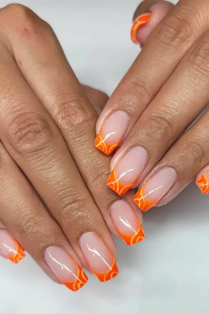 Long almond nails with burnt orange French tip design