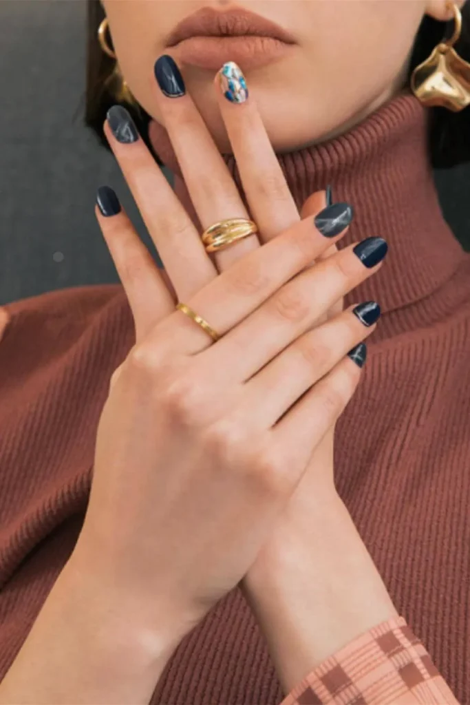 Gentle Cuticle Care Guide highlighting healthy skin and dark marble-effect nail art with gold accessories.